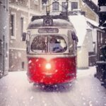 white and red cable train during winter