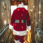 santa claus plush toy on brown wooden bench