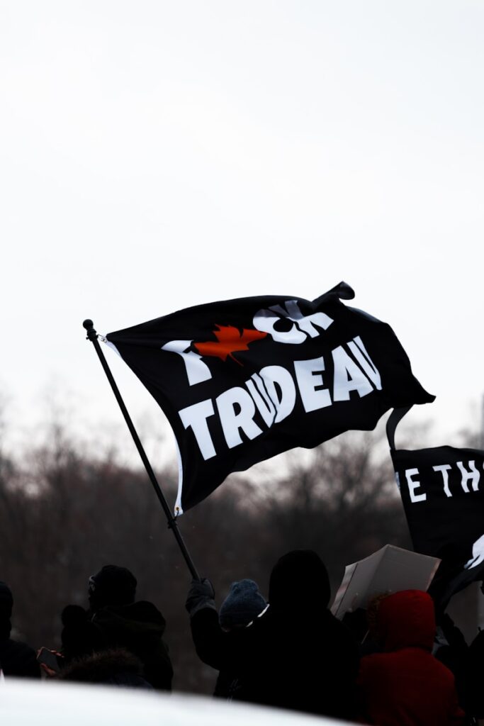 a group of people holding a black and white flag