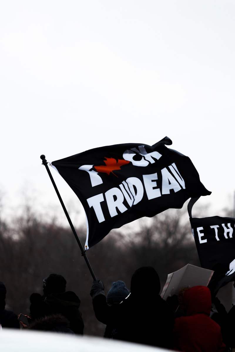 a group of people holding a black and white flag