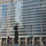 people walking on road beside Trump building