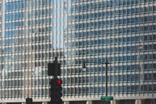 people walking on road beside Trump building