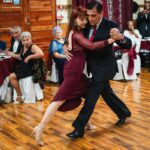 A couple of people that are dancing on a wooden floor