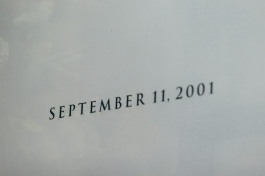 a close up of a plane flying in the sky