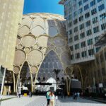 a couple of people standing in front of a building